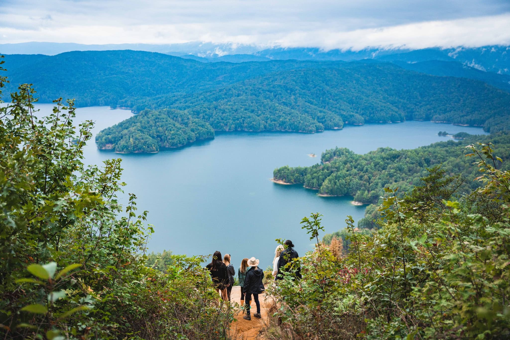 Hikers overlooking Lake Jocassee from mountain trail
